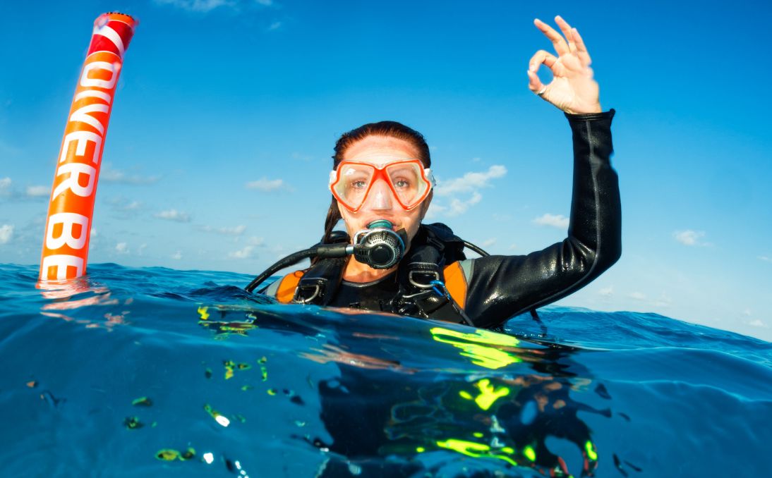 Scuba diver on the surface giving the OK signal